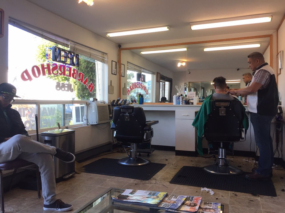 Two vintage barber chairs and mirror station inside Jess Barber Shop, Seattle